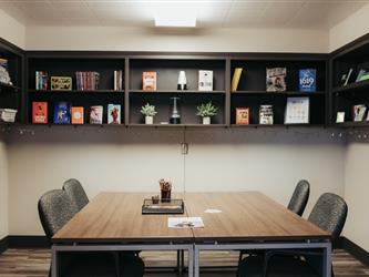 Table, chairs, and bookshelves